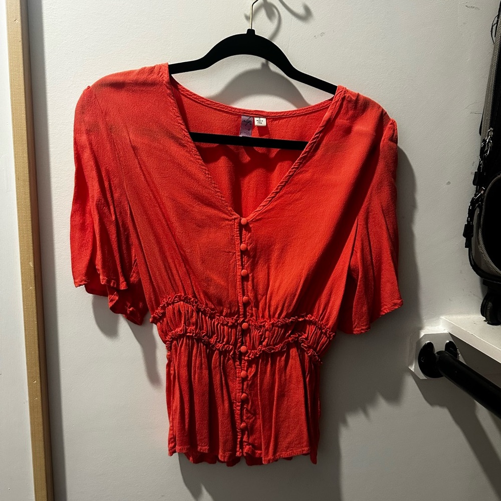 Red Peplum like top, great to wear with jeans for a casual outfit!